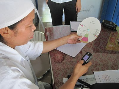 Woman using the reporting wheel to report a diagnoses 